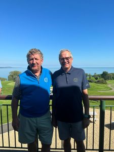 2 men smiling on balcony